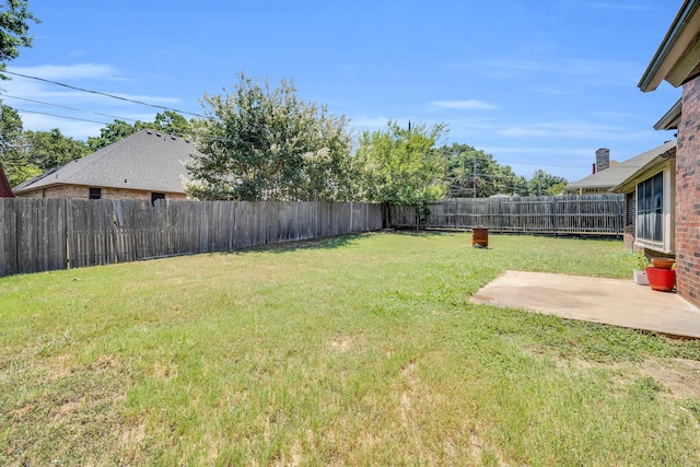 view of yard featuring a patio and a fenced backyard