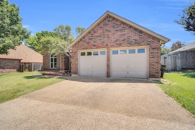 view of property featuring a garage and a front lawn