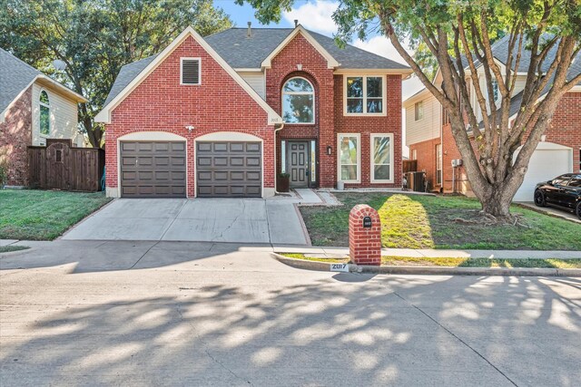 view of front of property with a garage and a front lawn