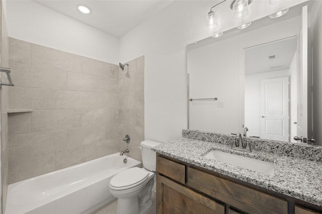 full bathroom with toilet, tiled shower / bath, and vanity