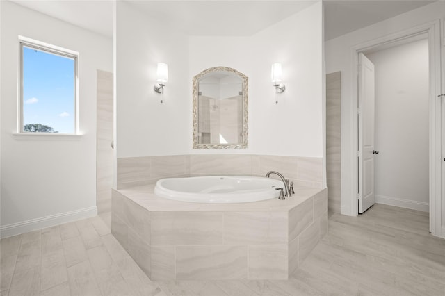 bathroom featuring tile patterned floors and tiled tub