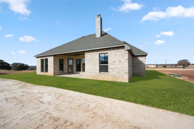 back of property featuring a patio area and a lawn