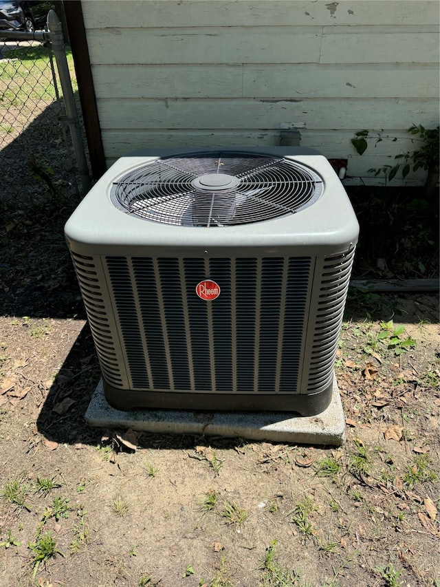 details featuring cooling unit and wooden walls