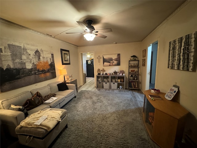 living room with ceiling fan, ornamental molding, and carpet floors