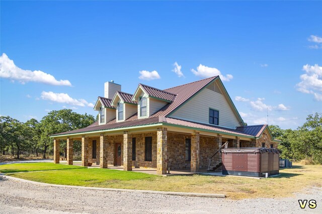 view of home's exterior featuring a hot tub and a yard