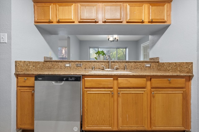 kitchen with sink, light stone counters, and stainless steel dishwasher