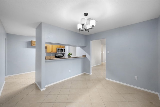 interior space with light tile patterned floors and a chandelier