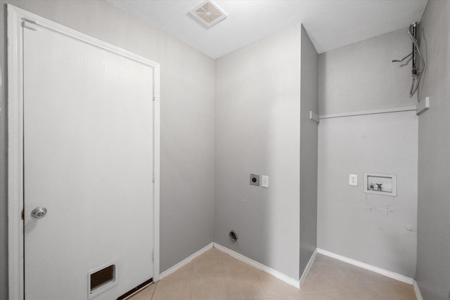 laundry area with electric dryer hookup, light tile patterned flooring, and washer hookup