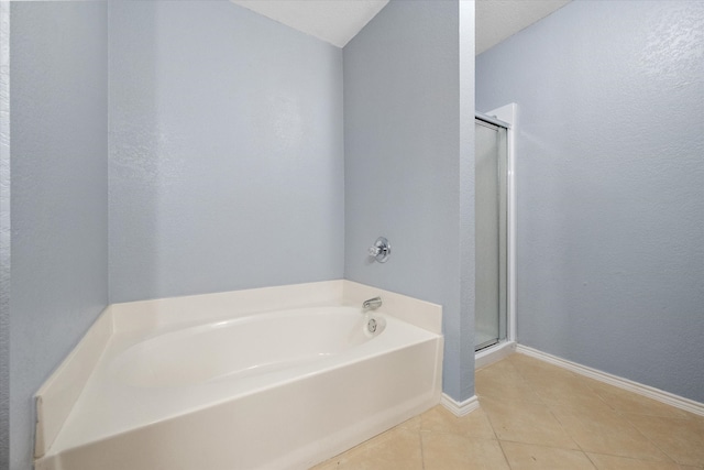 bathroom with independent shower and bath and tile patterned flooring