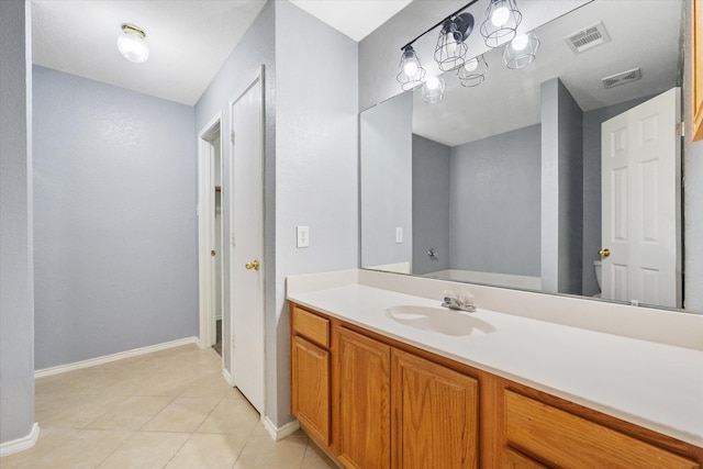 bathroom with tile patterned floors and vanity