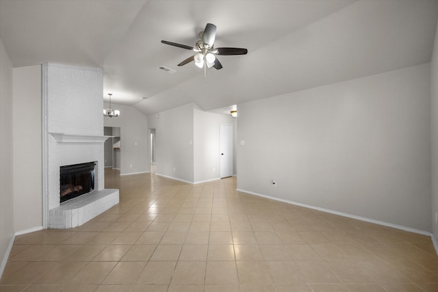 unfurnished living room featuring a brick fireplace, ceiling fan with notable chandelier, light tile patterned floors, and vaulted ceiling