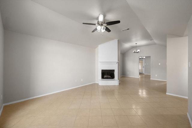 unfurnished living room with light tile patterned floors, ceiling fan with notable chandelier, lofted ceiling, and a brick fireplace