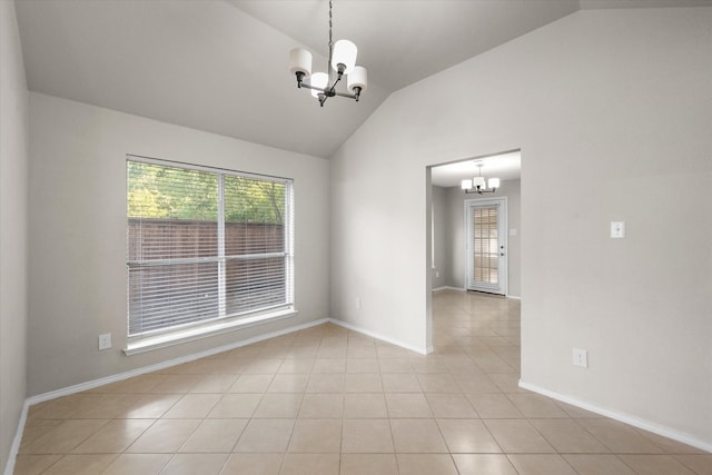 unfurnished room with tile patterned flooring, lofted ceiling, and a chandelier