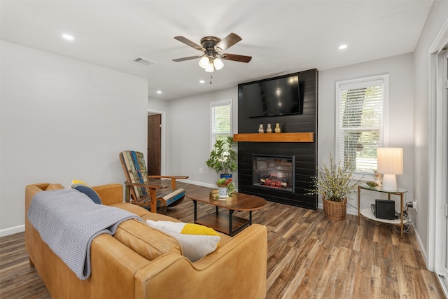 living room featuring hardwood / wood-style floors, a wealth of natural light, ceiling fan, and a fireplace