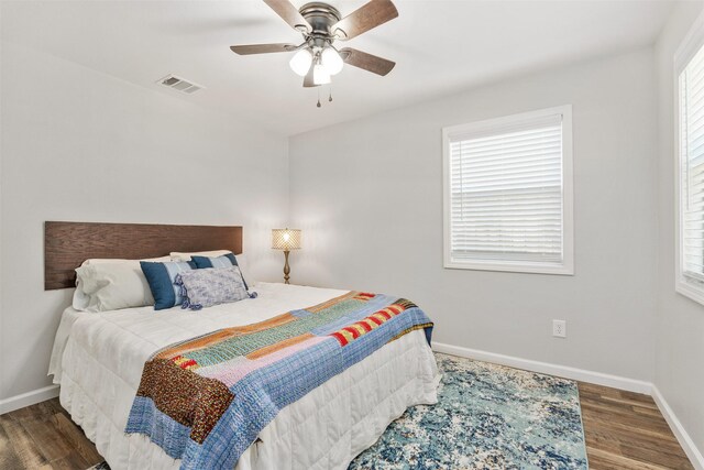 bedroom with ceiling fan and dark hardwood / wood-style flooring