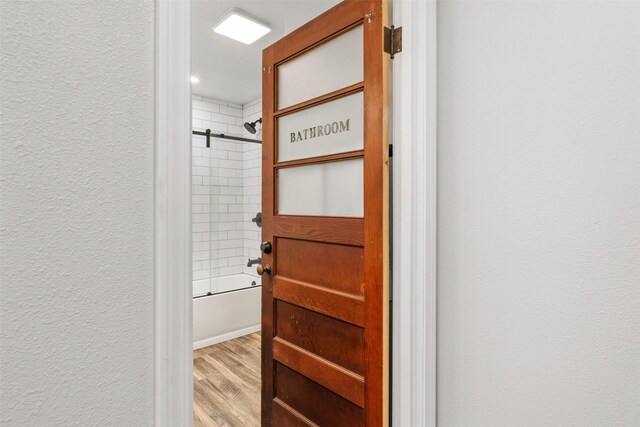 walk in closet with hardwood / wood-style flooring