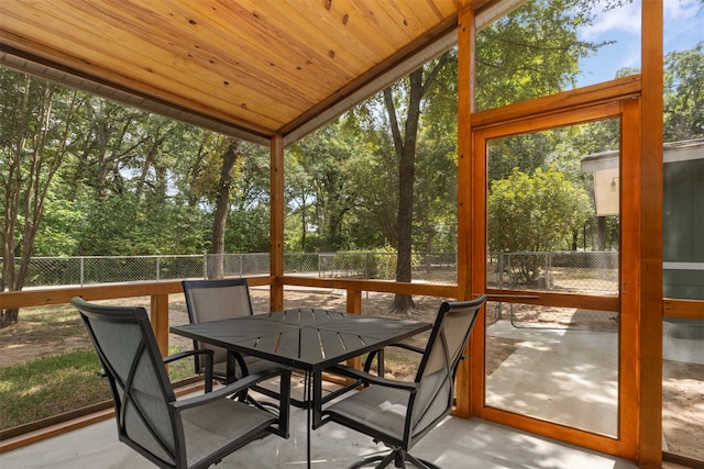 sunroom / solarium featuring vaulted ceiling and wood ceiling