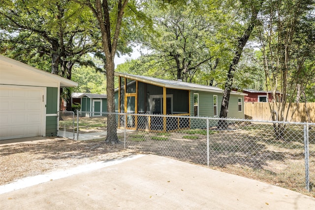 view of front of house featuring a sunroom and a garage