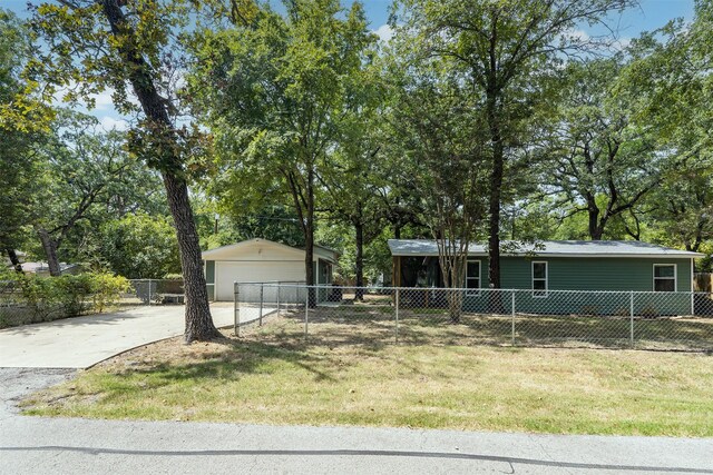 view of front of home with a front yard and a garage