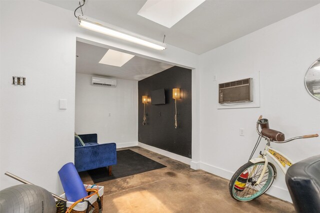 misc room featuring concrete floors and a wall mounted AC