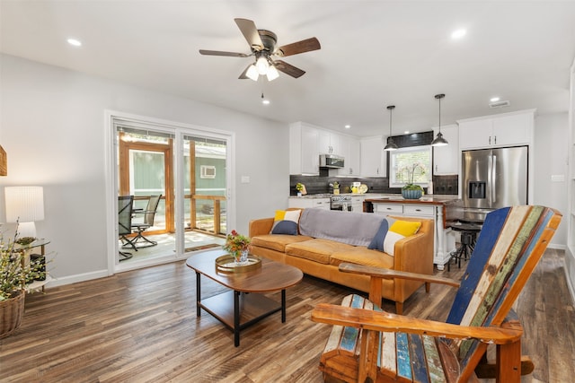 living room featuring ceiling fan and hardwood / wood-style floors