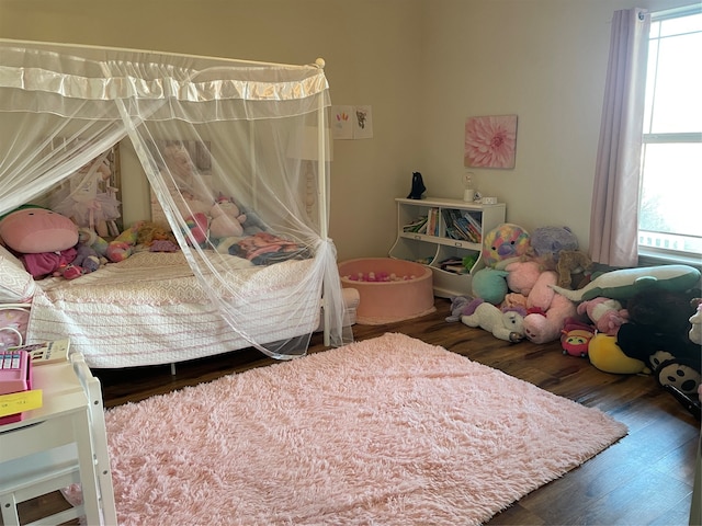 bedroom with dark hardwood / wood-style flooring