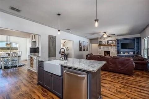 kitchen featuring dishwasher, dark hardwood / wood-style flooring, sink, and a wealth of natural light