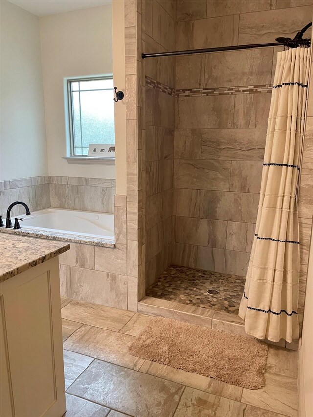 bathroom with vanity, plus walk in shower, and tile patterned flooring