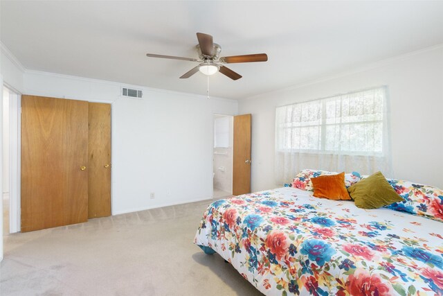 carpeted bedroom featuring ceiling fan and ornamental molding