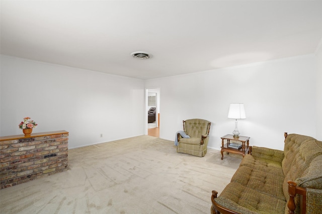 sitting room featuring light colored carpet and ornamental molding