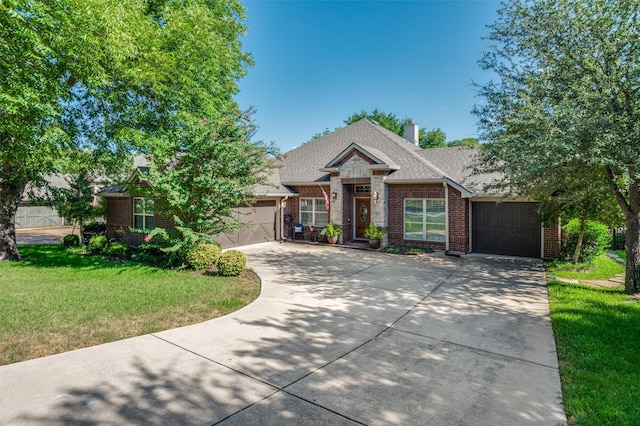 craftsman-style home with an attached garage, brick siding, concrete driveway, roof with shingles, and a front lawn