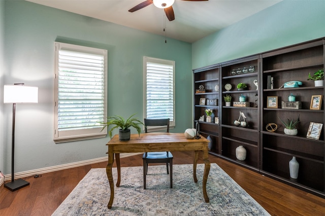 office area with ceiling fan, dark wood finished floors, and baseboards