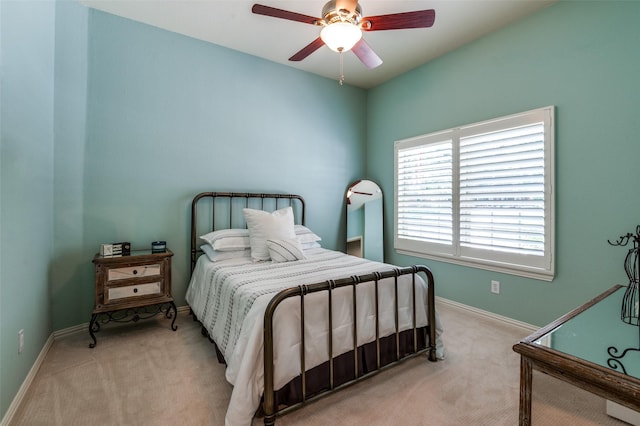 bedroom featuring baseboards, ceiling fan, and light colored carpet