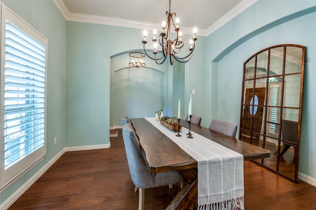 dining room with a notable chandelier, crown molding, and dark hardwood / wood-style flooring