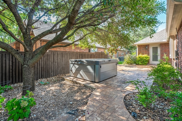 view of yard with a patio and a hot tub