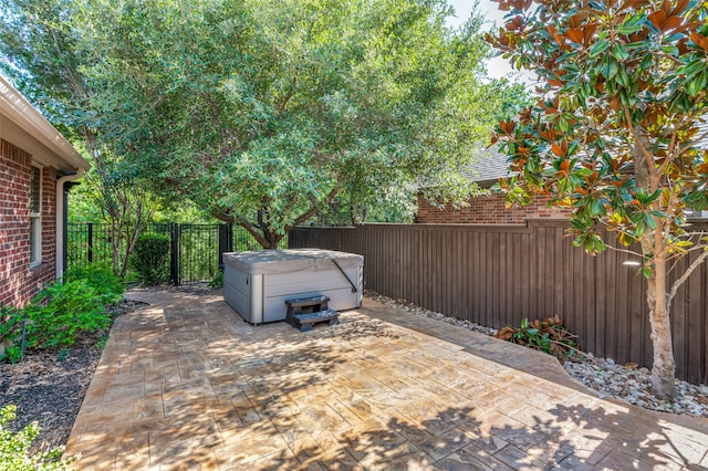 view of patio / terrace with a hot tub