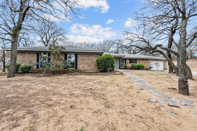 single story home featuring brick siding and driveway