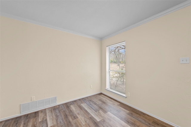 unfurnished room with light hardwood / wood-style flooring and ornamental molding