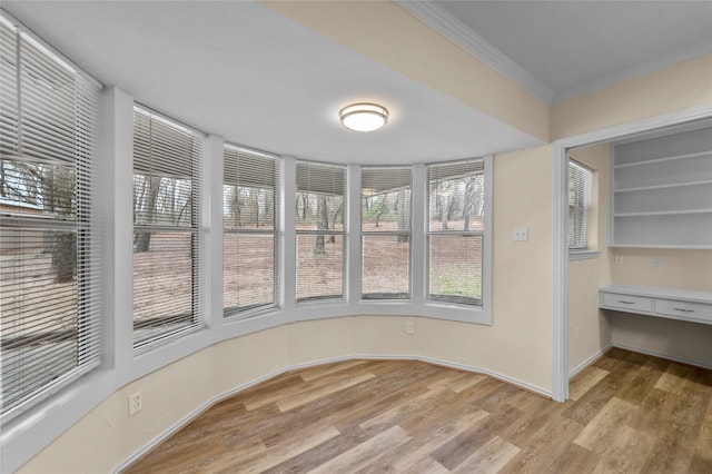 interior space featuring light hardwood / wood-style flooring and crown molding