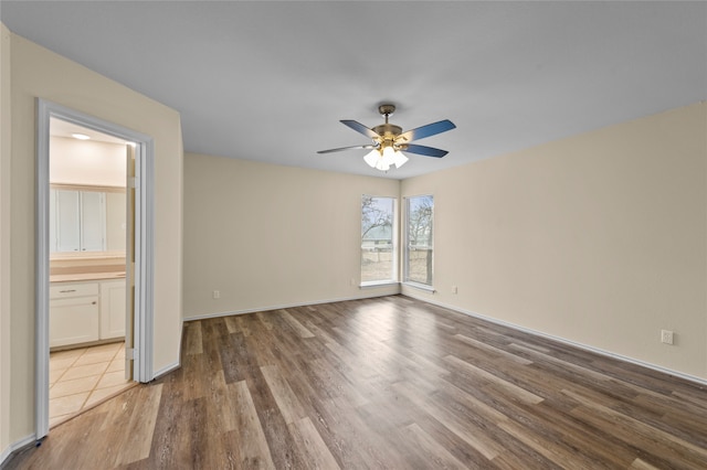 spare room featuring light wood-type flooring and ceiling fan