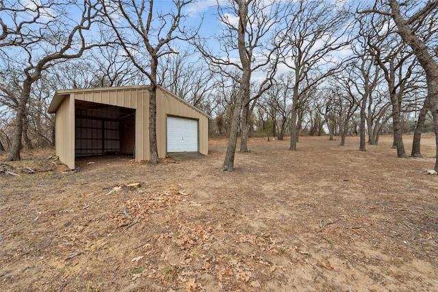 exterior space featuring a garage and an outdoor structure