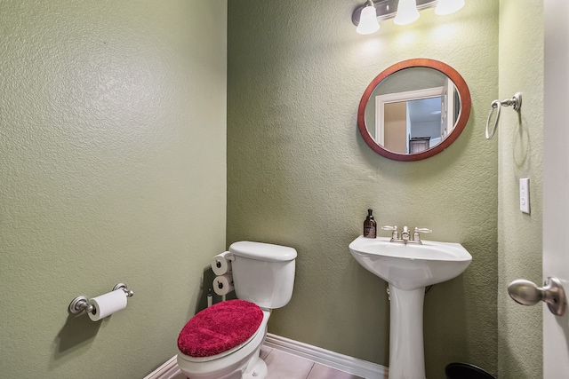 bathroom with tile patterned floors and toilet