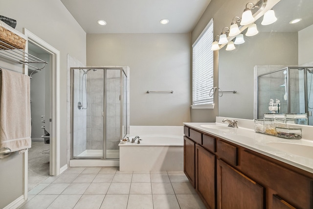 bathroom featuring double vanity, plus walk in shower, and tile patterned floors