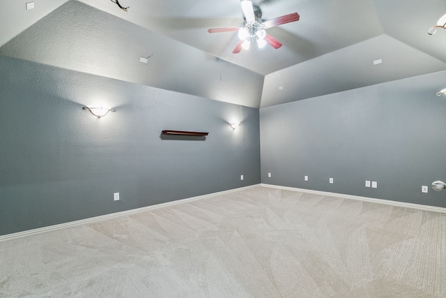 empty room with ceiling fan, carpet flooring, and lofted ceiling