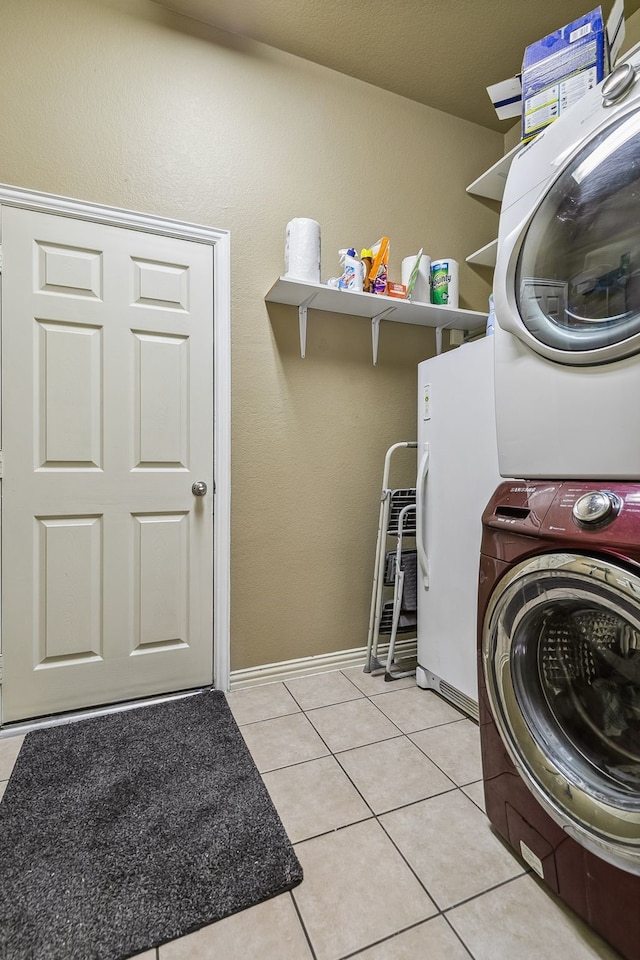 laundry area with light tile patterned flooring and stacked washer and dryer