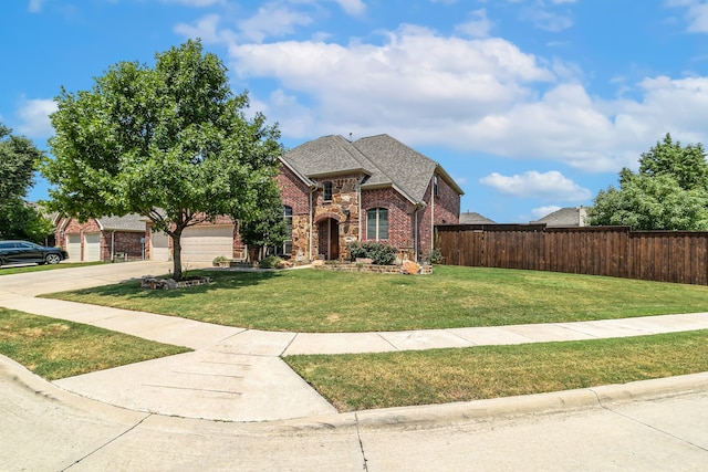 view of front of home with a front yard and a garage