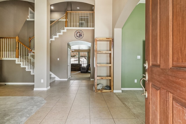 tiled entrance foyer featuring a high ceiling