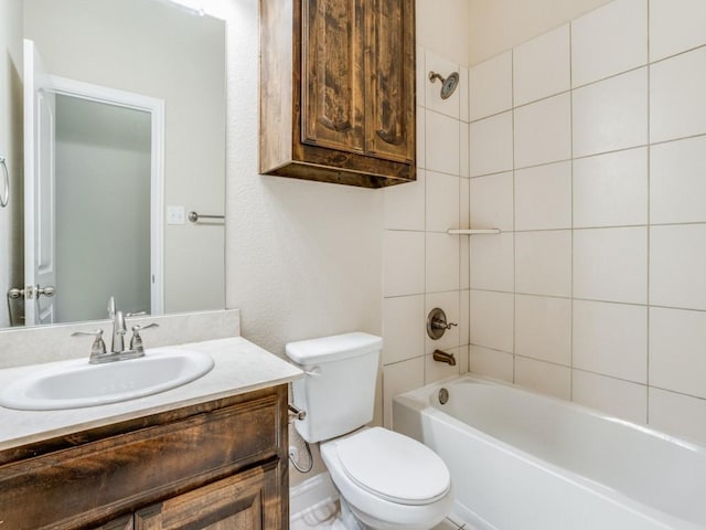 bathroom featuring toilet, vanity, and shower / tub combination