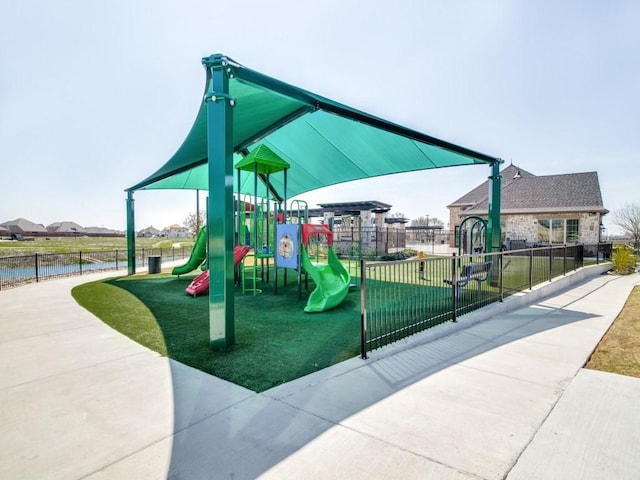 community playground featuring a yard and fence