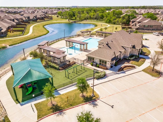 drone / aerial view with a water view and a residential view